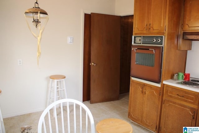 kitchen with gas stovetop, light tile patterned flooring, and wall oven