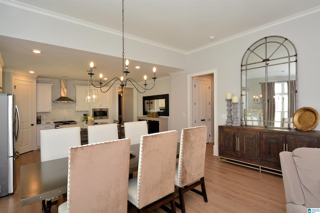 dining room featuring recessed lighting, an inviting chandelier, light wood-style flooring, and crown molding