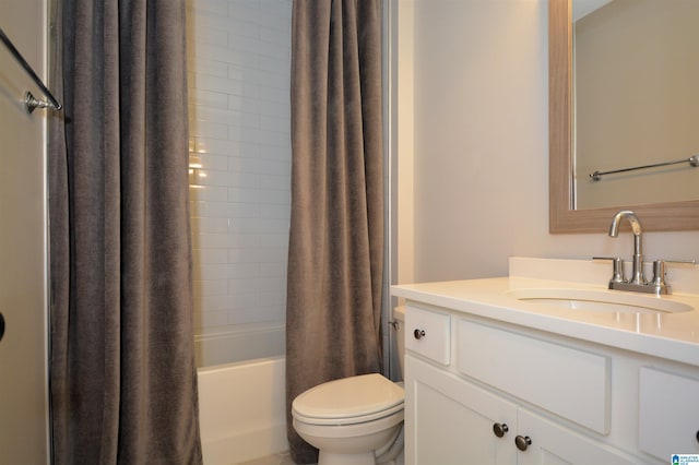 bathroom featuring vanity, shower / bath combo with shower curtain, and toilet