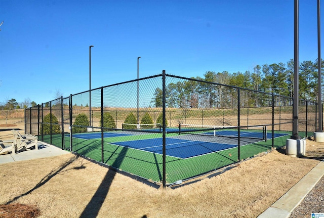 view of sport court featuring fence