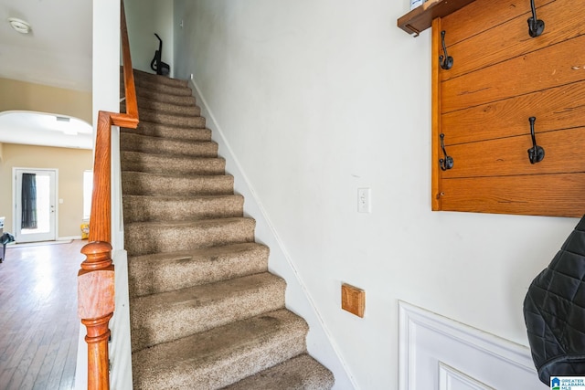 stairs featuring wood-type flooring