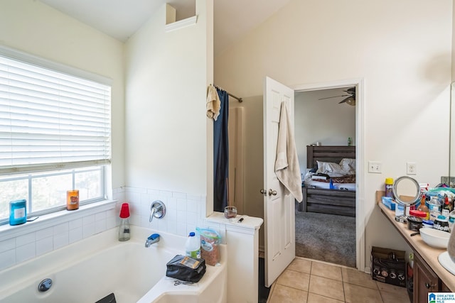 bathroom featuring a bath, tile patterned flooring, and vanity