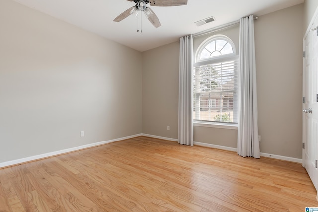 empty room with light hardwood / wood-style floors and ceiling fan