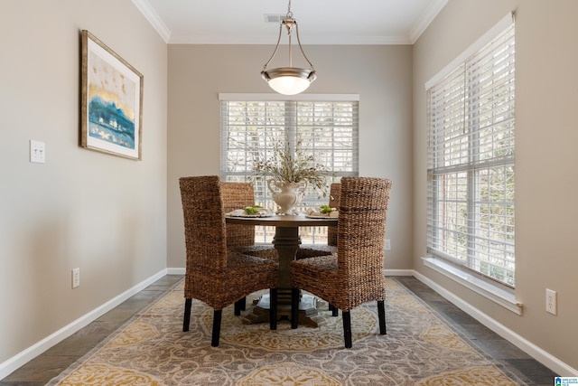 dining space featuring crown molding and a wealth of natural light