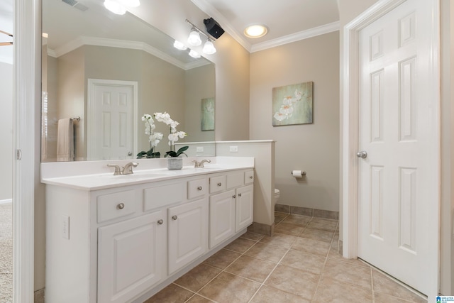 bathroom with tile patterned flooring, vanity, crown molding, and toilet