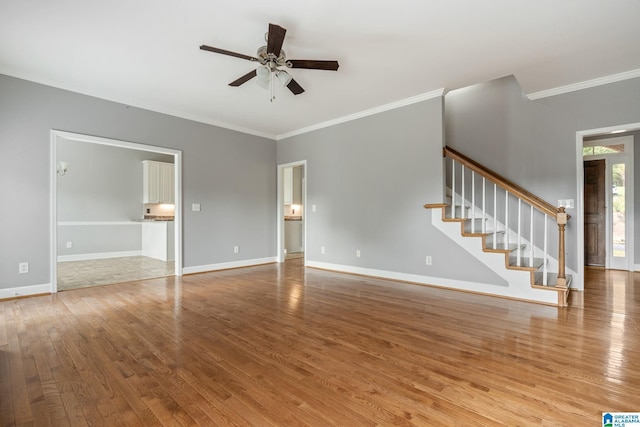 unfurnished living room featuring hardwood / wood-style flooring, ceiling fan, and ornamental molding