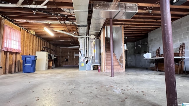 basement featuring water heater and heating unit