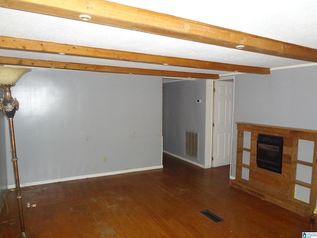 unfurnished living room with a fireplace, beamed ceiling, and dark hardwood / wood-style flooring