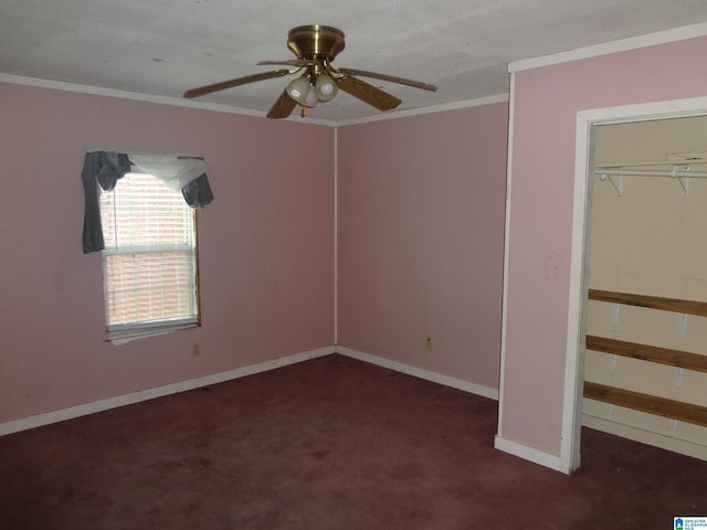 unfurnished bedroom with dark carpet, crown molding, and ceiling fan