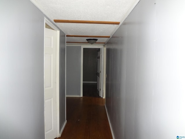 corridor featuring dark hardwood / wood-style flooring and a textured ceiling