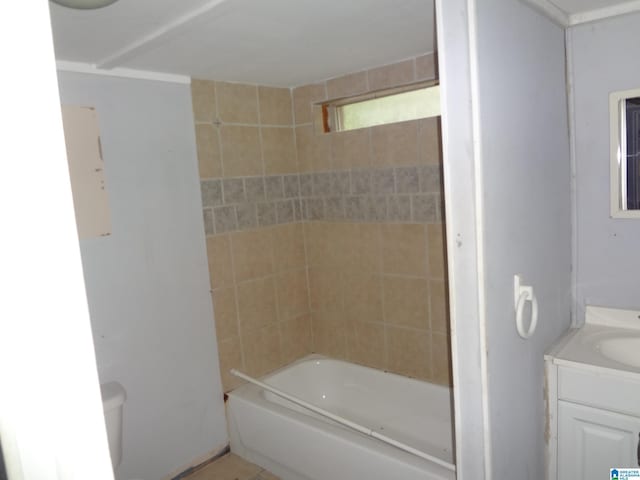 full bathroom with tiled shower / bath combo, vanity, and toilet