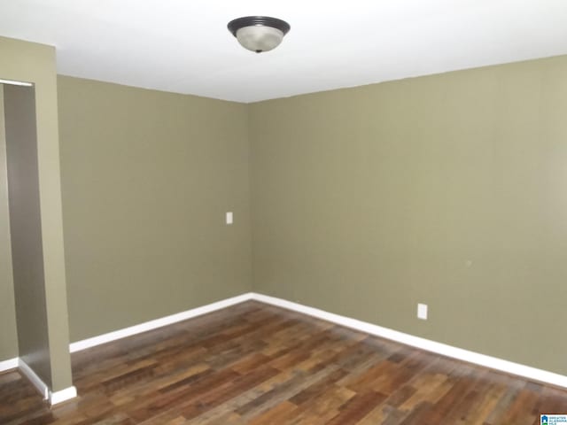 empty room featuring dark wood-type flooring