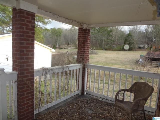 wooden terrace with a yard