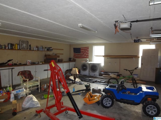 garage featuring washing machine and dryer and a garage door opener