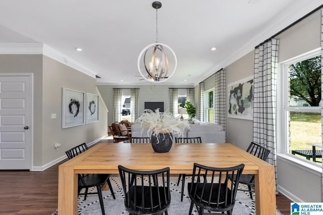 dining area featuring a chandelier, crown molding, a wealth of natural light, and dark hardwood / wood-style floors