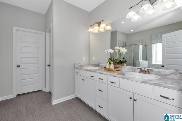 bathroom featuring vanity and an enclosed shower