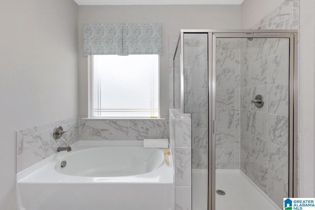 bathroom with separate shower and tub