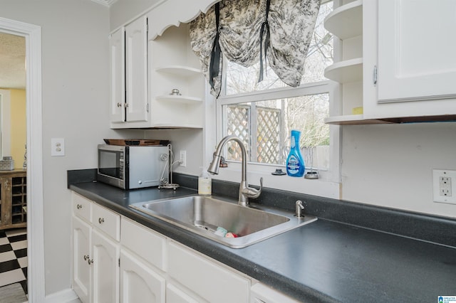 kitchen featuring white cabinetry and open shelves