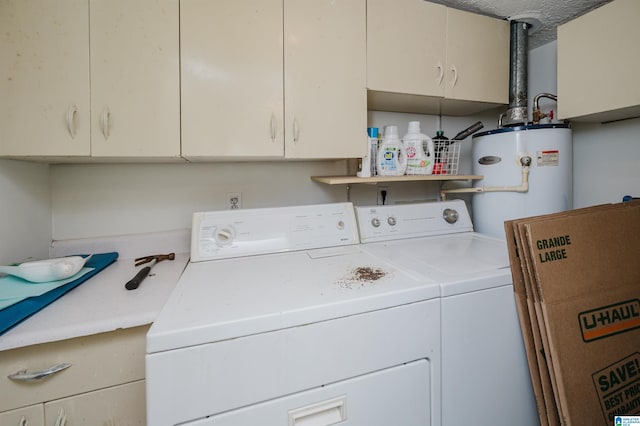 washroom with washer and dryer, gas water heater, and cabinet space