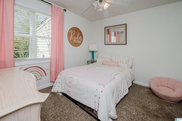 bedroom with a ceiling fan, baseboards, and carpet flooring