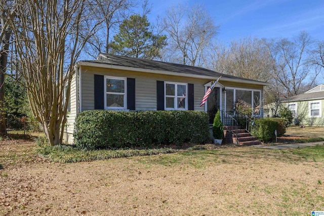 bungalow featuring a sunroom and a front lawn