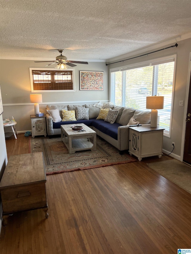 living room featuring a ceiling fan, dark wood-style flooring, a textured ceiling, and baseboards