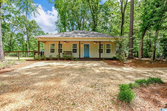 view of front of house with a ceiling fan, covered porch, a shingled roof, and fence