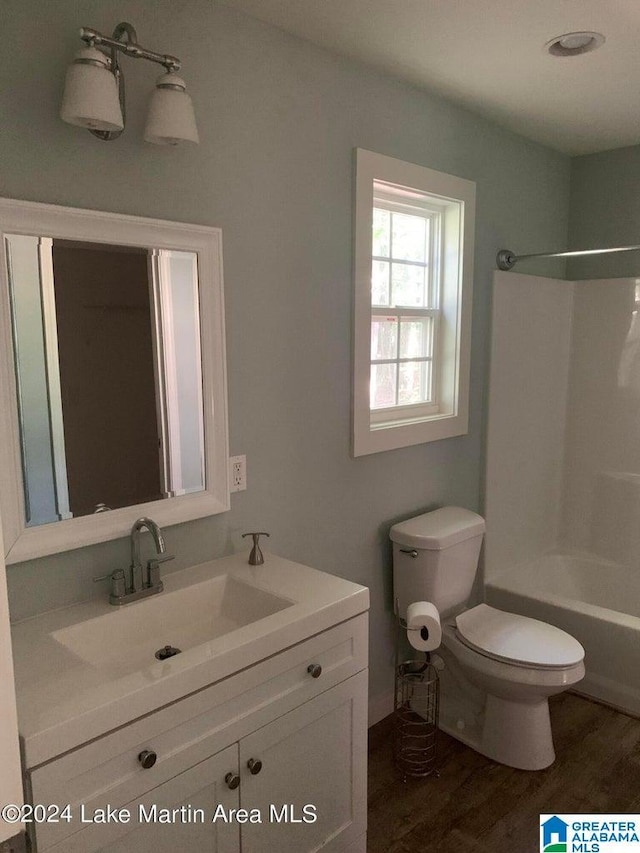 full bathroom featuring shower / tub combination, toilet, wood-type flooring, and vanity