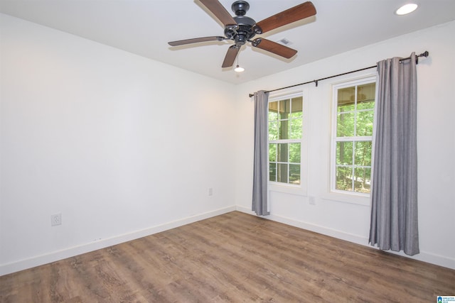 spare room featuring baseboards, wood finished floors, ceiling fan, and recessed lighting