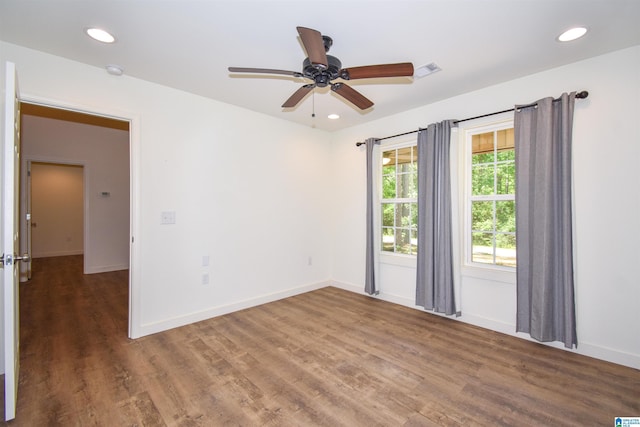 empty room with wood finished floors, baseboards, ceiling fan, recessed lighting, and a smoke detector