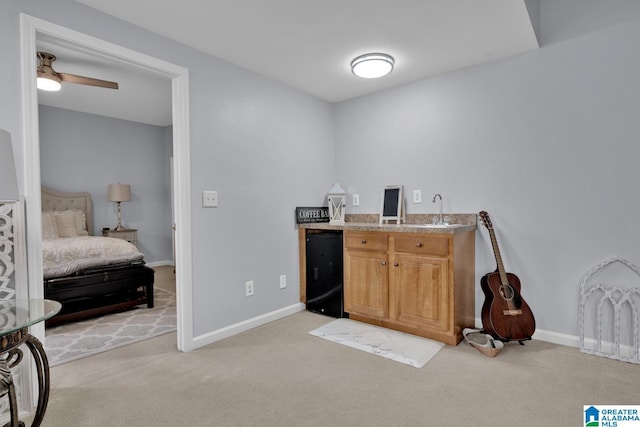 interior space featuring open floor plan, light countertops, a sink, and light colored carpet