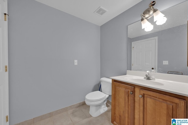 bathroom with visible vents, vanity, toilet, and tile patterned floors