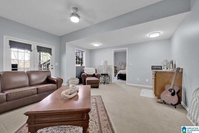 living area with light colored carpet and baseboards