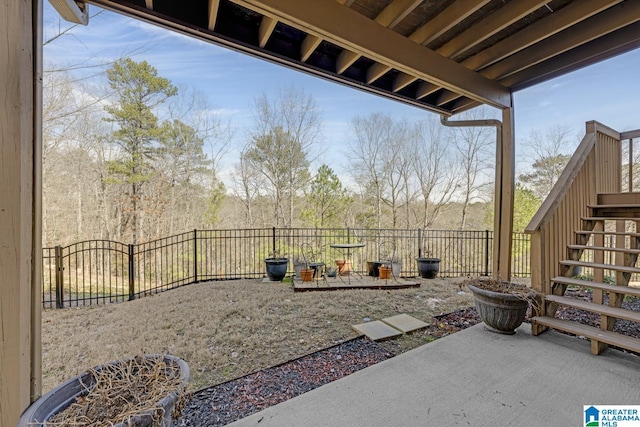 view of patio featuring stairway and a fenced backyard