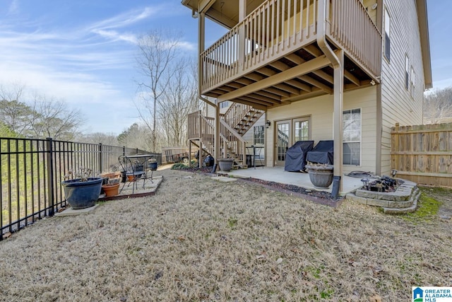 view of yard with stairs, an outdoor fire pit, a patio area, and a fenced backyard