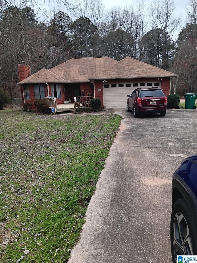 ranch-style house with a porch and a garage