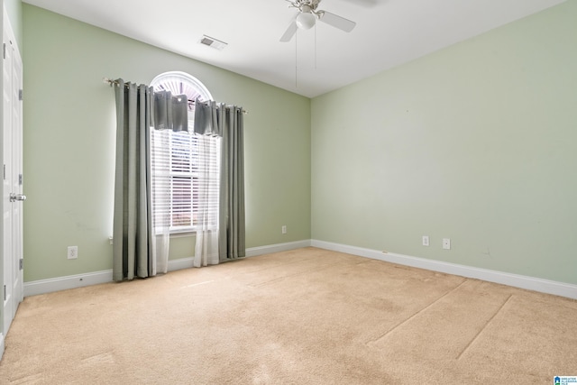 carpeted spare room with ceiling fan