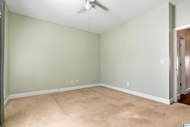 carpeted spare room with ceiling fan