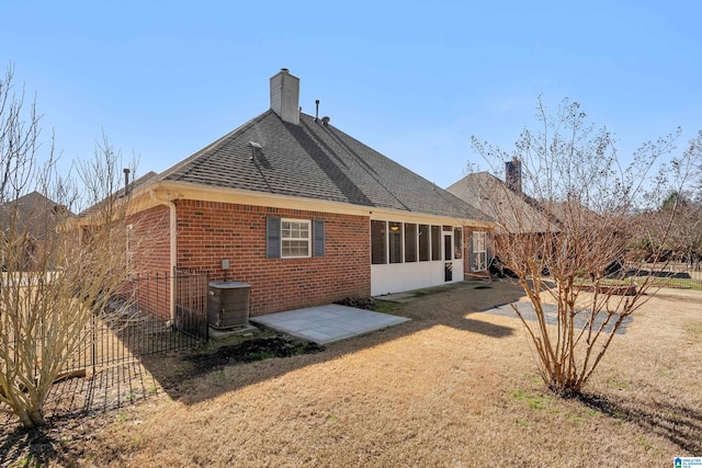 back of property featuring a lawn, a patio area, and central AC