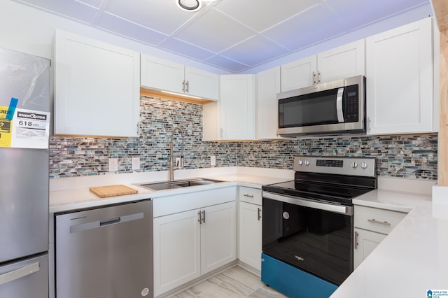 kitchen with appliances with stainless steel finishes, white cabinetry, and sink