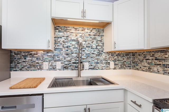 kitchen featuring sink, white cabinets, and decorative backsplash