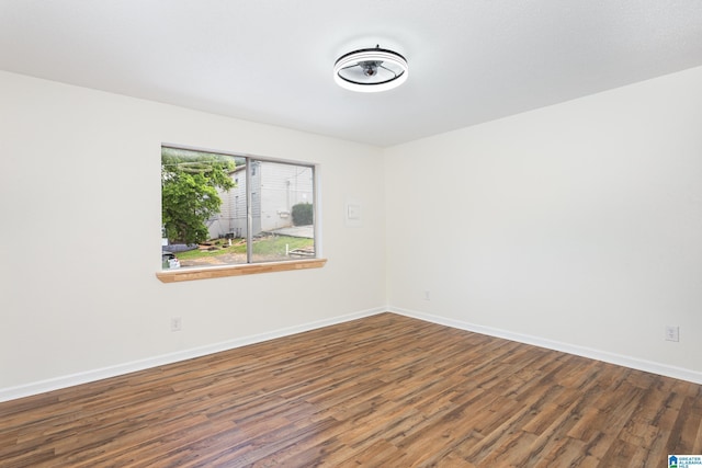 empty room with dark hardwood / wood-style floors