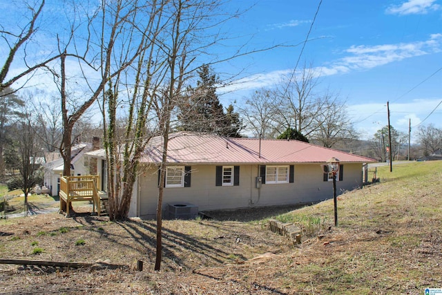 view of home's exterior featuring central AC unit and metal roof