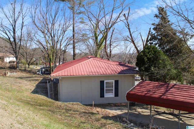 view of side of home featuring a yard and metal roof