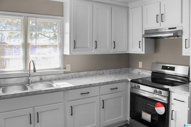 kitchen featuring under cabinet range hood, stainless steel electric range oven, white cabinets, and a sink