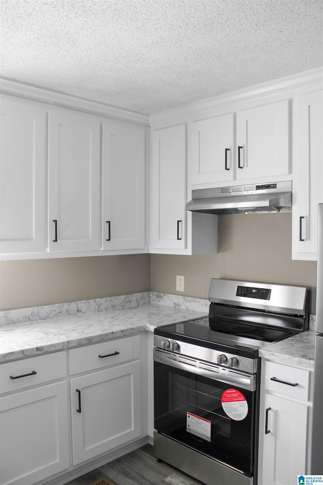 kitchen with a textured ceiling, under cabinet range hood, white cabinetry, and stainless steel electric stove