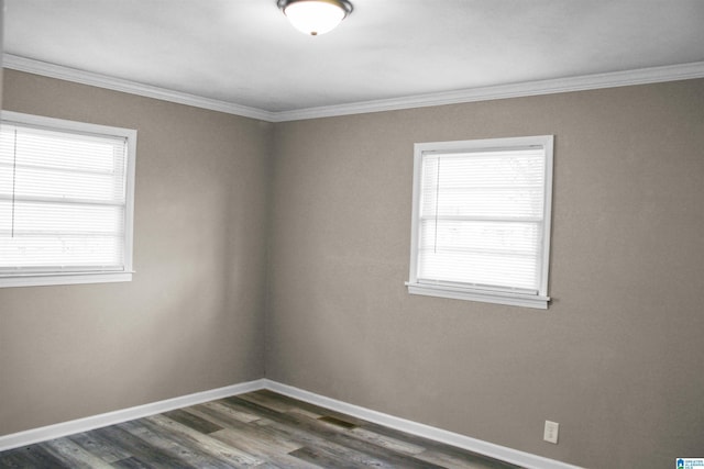 unfurnished room featuring ornamental molding, dark wood-style flooring, plenty of natural light, and baseboards