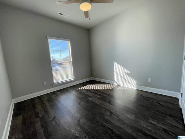 empty room with ceiling fan and dark hardwood / wood-style flooring