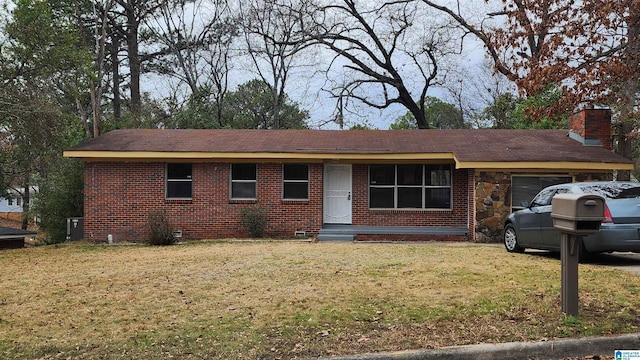 ranch-style house featuring a front lawn and a garage