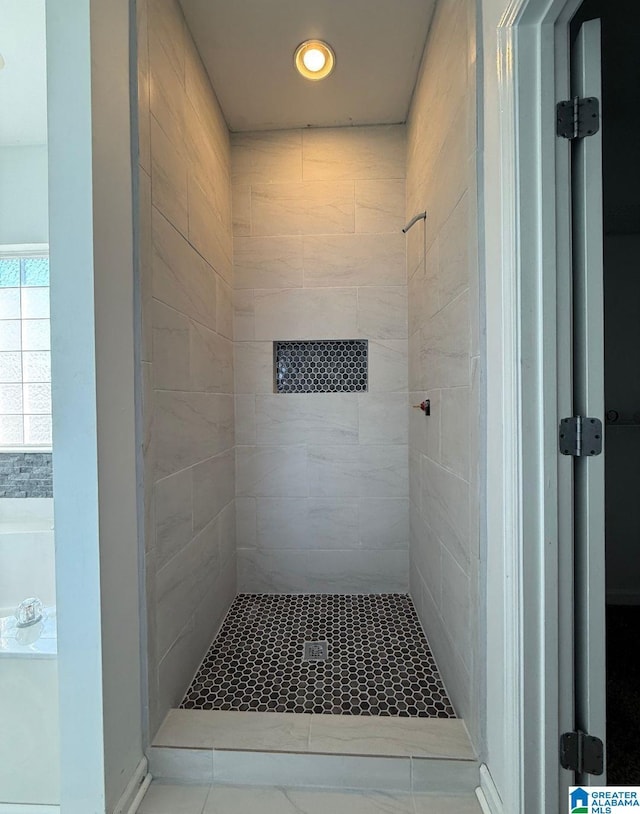 bathroom with a stall shower and a bath